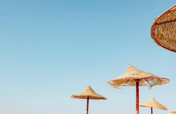 Соломенный зонтик или соломенная хижина с прекрасным видом на небо на тропический пляж — стоковое фото