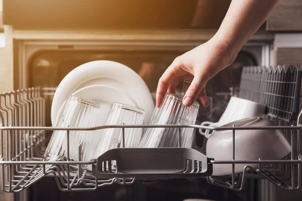 Open dishwasher with clean cutlery, glasses, dishes inside in the home kitchen — Stock Photo, Image