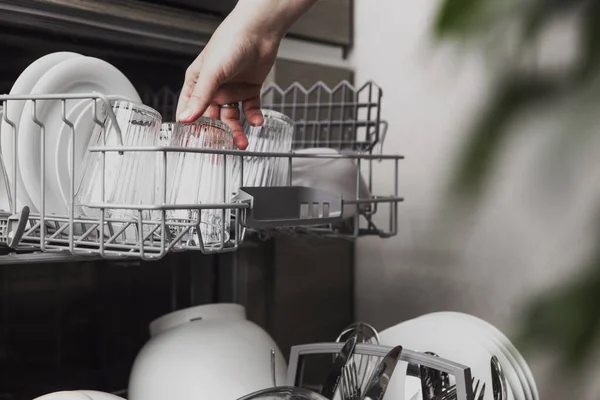 Open dishwasher with clean cutlery, glasses, dishes inside in the home kitchen — Stock Photo, Image