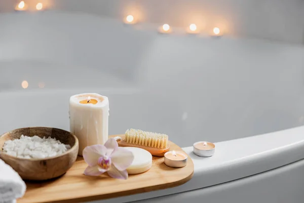 Hotel spa treatment or home bath procedure. Bathroom with accessories on tray