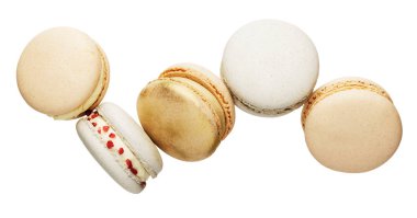 Isolated white, yellow, gold macaron cookies falling in the air