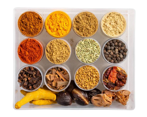 Colorful  spices in plastic containers isolated on white. Indian spice set. Top view.