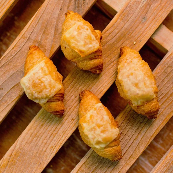 Small Tasty Puff Pastries Sorted Wooden Table Top View — 图库照片