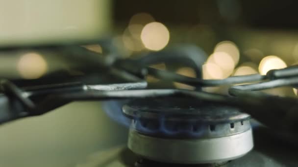 Enciendo el gas de la estufa. Luces de Navidad en el fondo — Vídeos de Stock