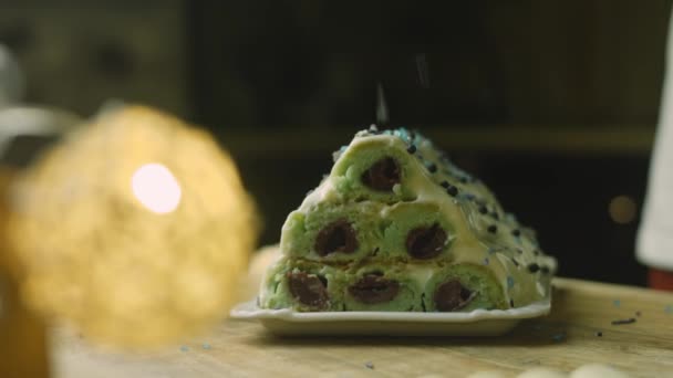 Press food ornament over the cake with green dough, cherries and sour cream — Stock Video