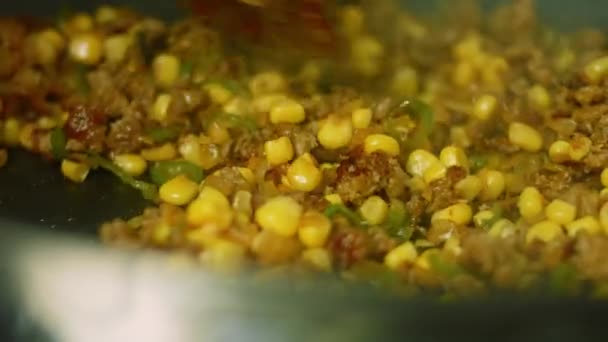 J'ajoute le maïs aux ingrédients chorizo. Faire frire le tout dans une casserole. Prise de vue macro — Video