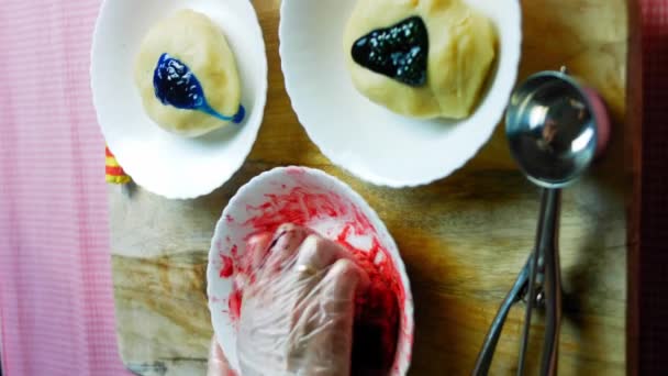 I put the food coloring on the baking dough. Mix the dough with the red color — Stock Video