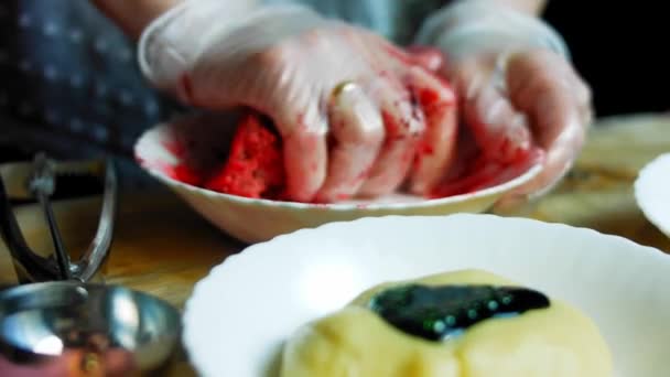 I put the food coloring on the baking dough. Mix the dough with the red color — Stock Video