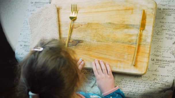 머스터드 Vegetables 요리사는 접시를 놓는다 소녀는 앉아서 음식을 기다리고 있습니다 — 비디오
