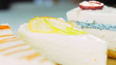 Arka arkaya dizilmiş dört çeşit cheesecake. Kaypak ve makro atış. Bir retro stil pişirme tahtası kullanılır.