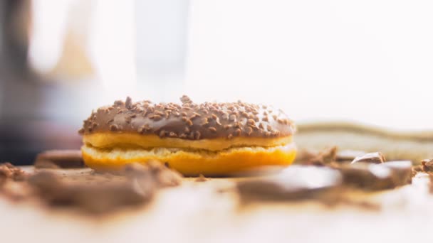 用巧克力装饰的巧克力甜甜圈 甜甜圈在用天然巧克力装饰的纸上 宏观和滑翔机射击 面包店和食品概念 各种彩色甜甜圈 巧克力 粉红色 — 图库视频影像