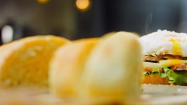 Fransız ekmeği, peynir, salata yaprakları ve sosisle sanvich 'in üzerinde kaynayan kalp şeklinde sahanda yumurta. Kaydırıcı atışı.