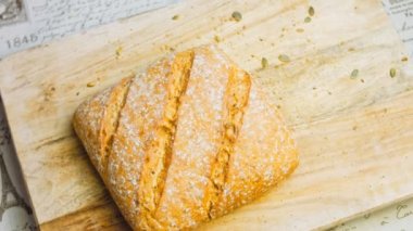 Çizgileri olan taze pişmiş kare ekmek. Arka planda romantik bir ortam var. Kahverengi arka planda münferit bir ekmek çeşidi. Kaydırıcı atışı.