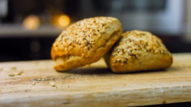 İki taze pişmiş kare ekmek ve tohum. Arka planda romantik bir ortam var. Makro ve sürgülü atış.