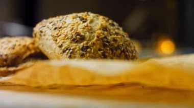 İki taze pişmiş kare ekmek ve tohum. Arka planda romantik bir ortam var. Makro ve sürgülü atış.