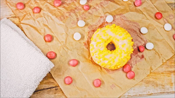 Chocolate, marshmello and candy donuts on a retro baking tray. Donuts are on a paper decorated with natural chocolate. Macro and slider shooting. Various colorful donuts. Chocolate, pink, blue donuts.