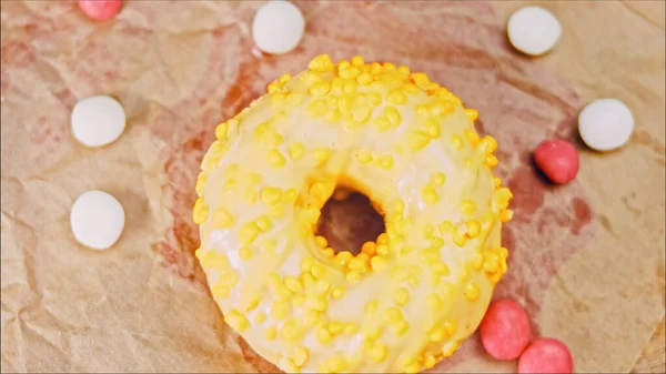 Chocolate, marshmello and candy donuts on a retro baking tray. Donuts are on a paper decorated with natural chocolate. Macro and slider shooting. Various colorful donuts. Chocolate, pink, blue donuts.