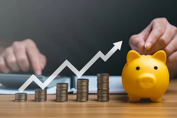 Businessman Holding Coin Piggy Bank Graphs Arrows Showing Charts His —  Fotos de Stock