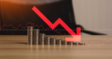 Concept inflation, pile of coins and red arrows on the desk.  Economic conditions in which the currency tends to decline continuously. higher price inflation and more expensive food