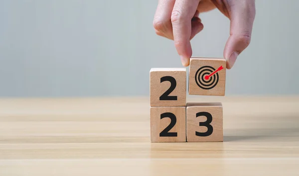 New Year\'s goals 2023. Holding a wooden block with goals 2023, on the wooden table background. year ,new life, new business, plan, goals, strategy concept