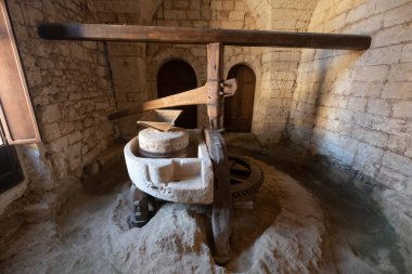 Italy Calabria Miglierina: Ancient oil mill underground mill Catanzaro. Grey brick walls. Sunlight coming through the door.  clipart