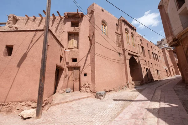 Ancient building in the mountain village Abyaneh, Iran. Zoroastrian village. Narrow street with unique houses. Characteristic red houses in the central part of Iran.