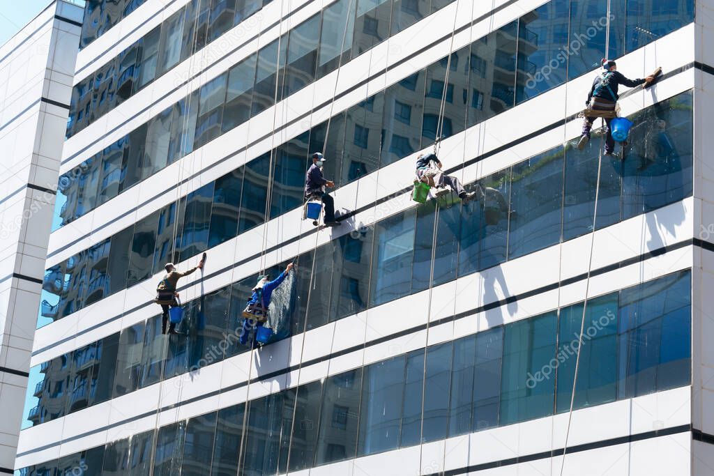 Workers washing windows in an office skyscraper.