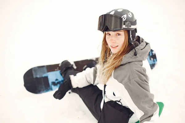 Girl snowboarding in the mountains with the snowboard — Stock Photo, Image