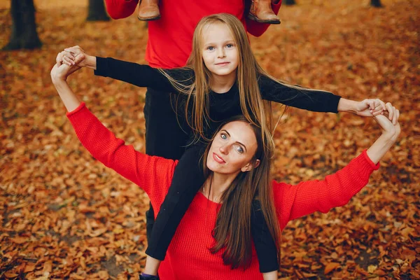 Family with cute kids in a autumn park — Stock Photo, Image