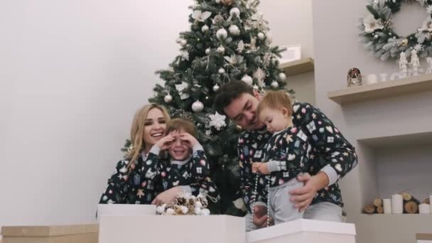 Famille de quatre cadeaux de Noël déballage près de l'arbre de Noël — Video