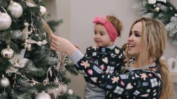 Mère festive et petite fille décorant l'arbre de Noël à la maison — Video