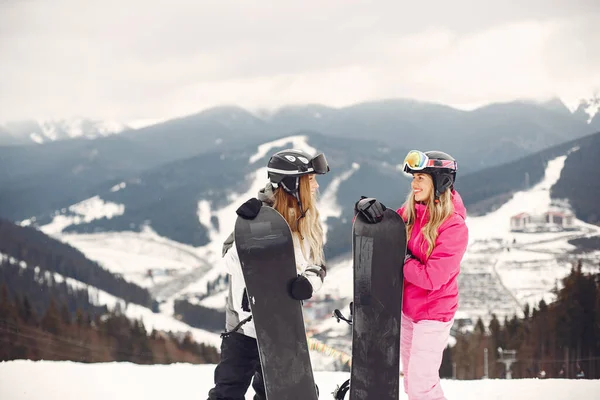 Niñas haciendo snowboard en las montañas con el snowboard —  Fotos de Stock