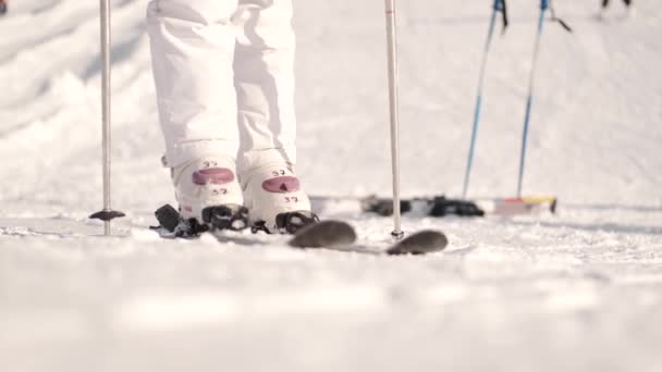 Young girl sliding down on hill in ski resort — Stock Video