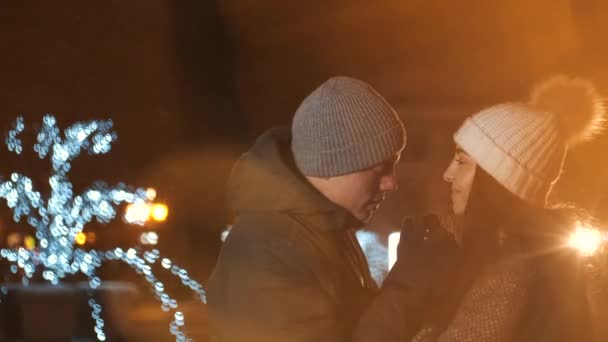 Jeune couple embrasse sous l'éclairage d'hiver vacances la nuit — Video