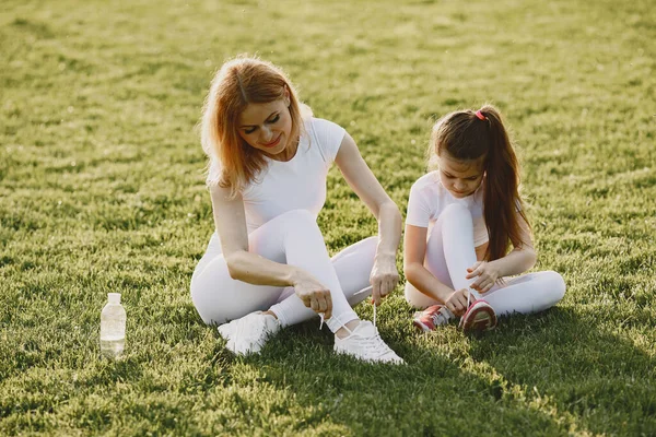 Sports family in a summer park — Stock Photo, Image