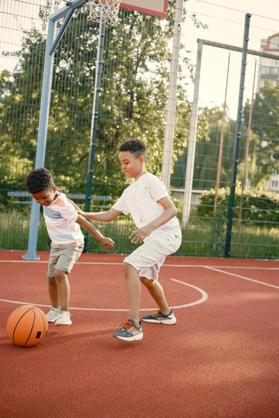 两个兄弟一起在篮球场打篮球 — 图库照片