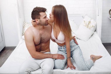 Bir çift bir odada yatakta yatıyor.