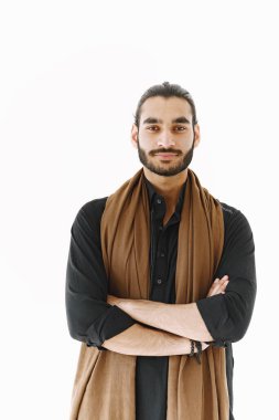 Genç Müslüman adam beyaz duvarın üzerinde gelişigüzel poz veriyor. Stüdyo, izole.