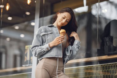 Woman standing in a summer city with ice cream