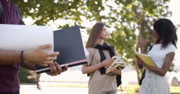 Cropped view man student holding textbook outdoors — Stockvideo