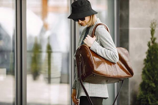 Portrait of a fashionable model with big brown bag outdoors — стоковое фото