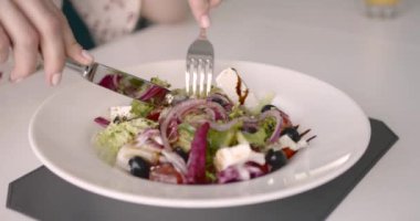 Young European woman having lunch in a restaurant