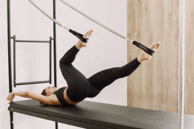 Young woman streching muscles in functional training