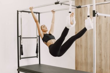 Young woman streching muscles in functional training