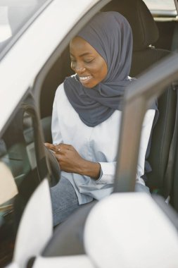 Afrian american woman using tablet in white car