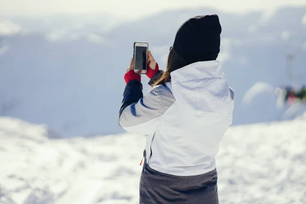 Молода і активна брюнетка катається на лижах у засніжених горах — стокове фото