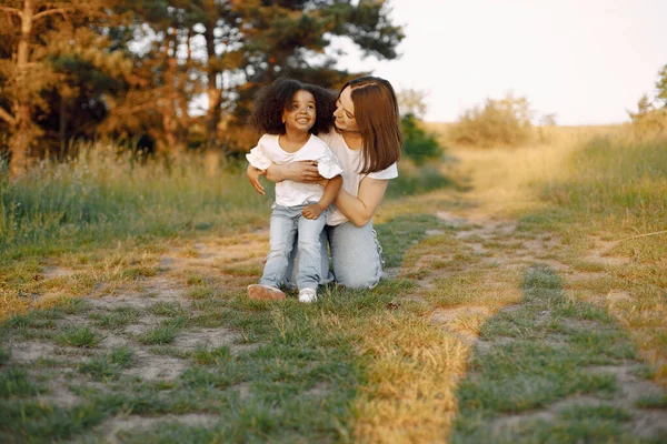 Caucasian mother embracing her mixed race daughter — Stock Photo, Image