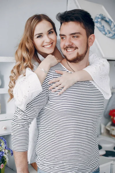 Beautiful couple spend time in a kitchen — Stock Photo, Image