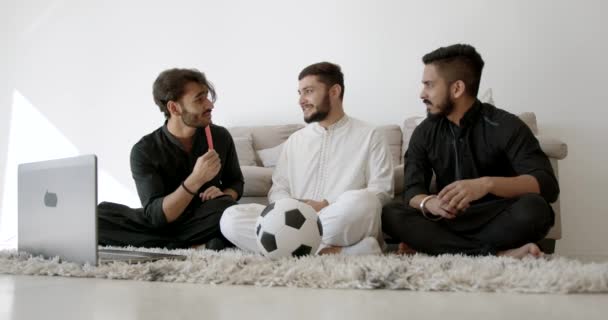 Three Indian young men watching football at home — Vídeo de Stock
