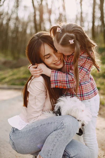 Mother with daughter in a spring forest with dog — Stock Photo, Image